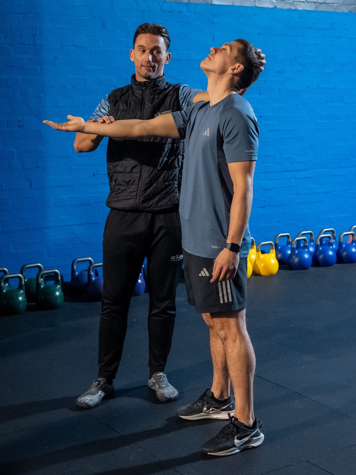 Coach Craig checking a member's shoulder mobility
