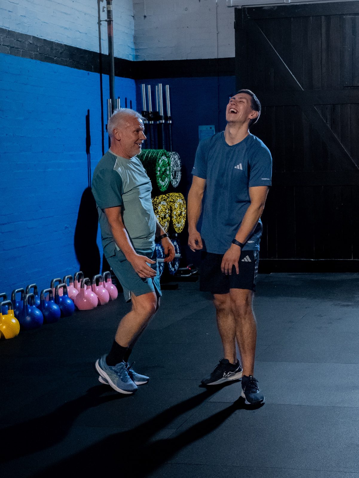 Coach Craig sharing a laugh with a member mid-session