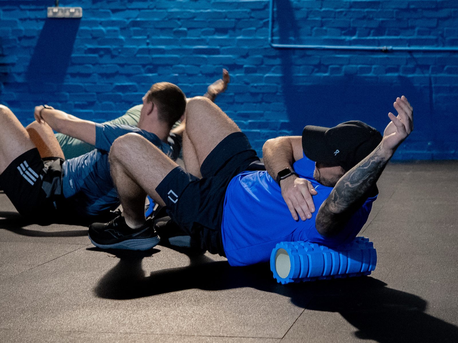 Members foam rolling during the cool-down